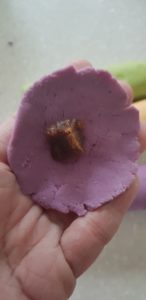wrap a piece of gula melaka into an ondeh ondeh