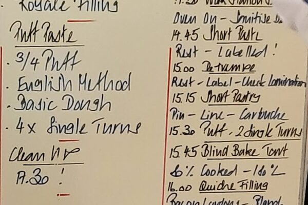 quiche lorraine Chef Mario's hand writing on the board during basic course